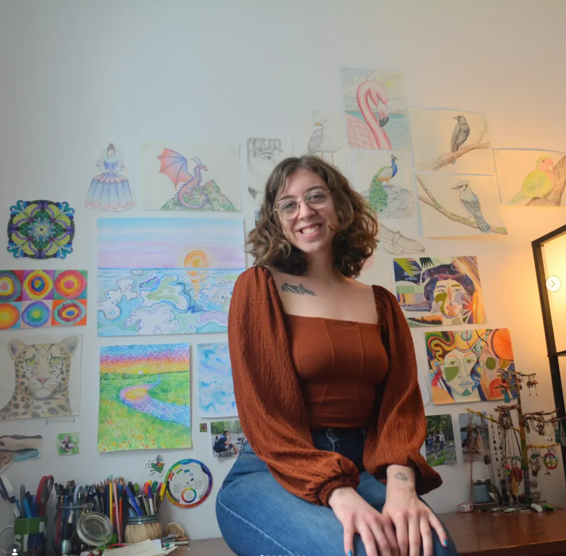 Holly Alaine Staples in her studio, surrounded by her artwork